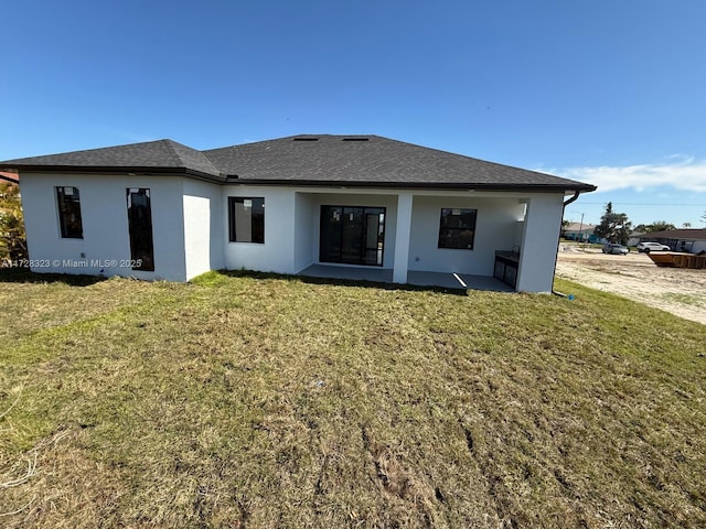 rear view of property with a yard