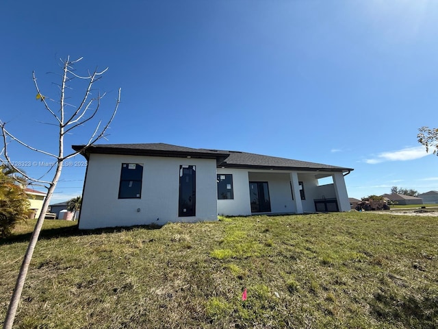 rear view of house with a lawn