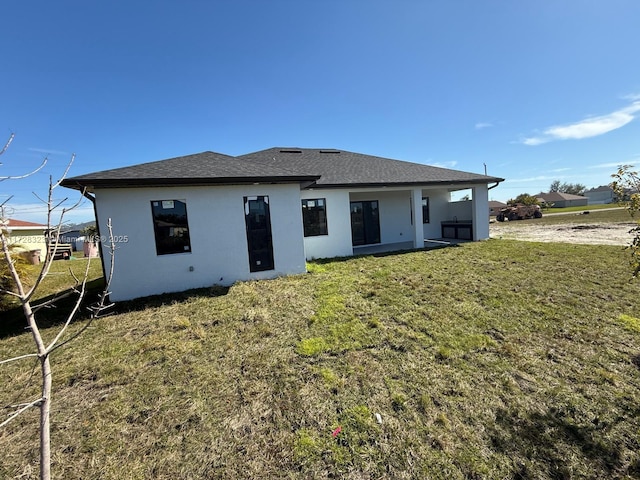 rear view of house with a lawn