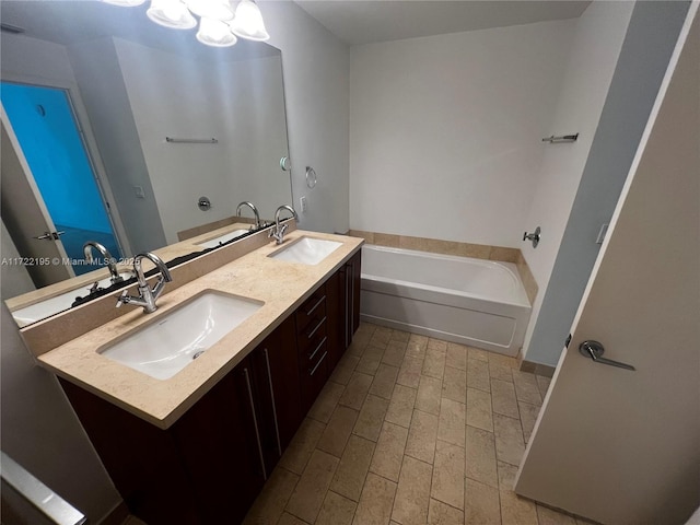 bathroom featuring vanity and a tub