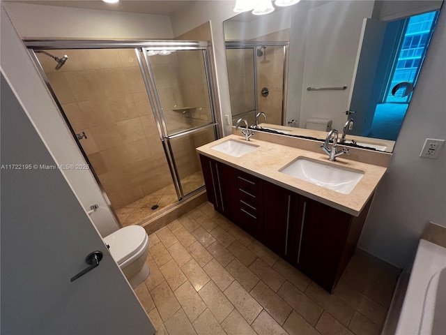 bathroom featuring toilet, tile patterned floors, an enclosed shower, and vanity