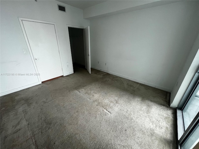 unfurnished bedroom featuring dark colored carpet