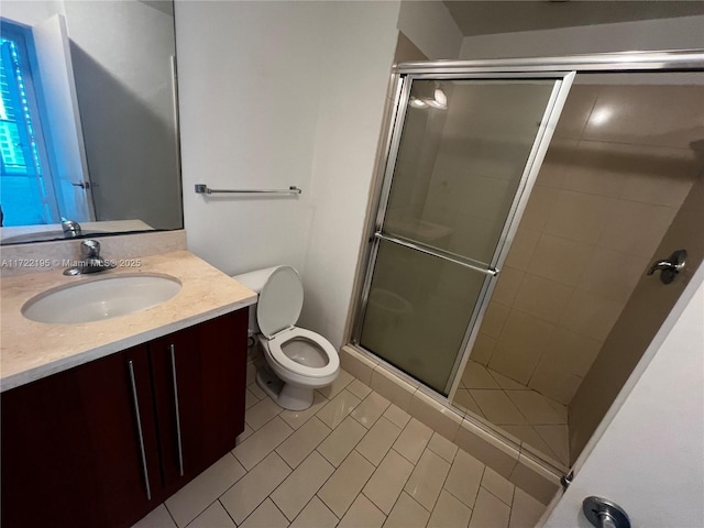 bathroom with toilet, tile patterned flooring, walk in shower, and vanity