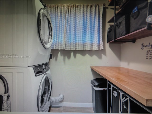 laundry area with stacked washer / dryer