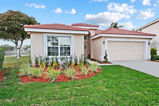 mediterranean / spanish home with a garage and a front yard