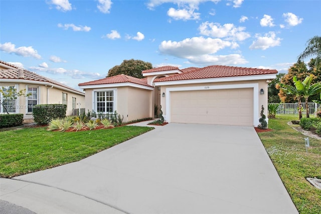 mediterranean / spanish home featuring a garage and a front lawn