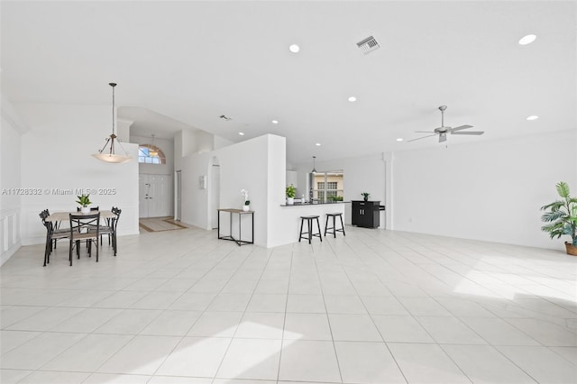 interior space featuring ceiling fan, light tile patterned floors, and ornamental molding