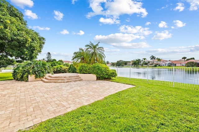 view of yard with a patio area and a water view