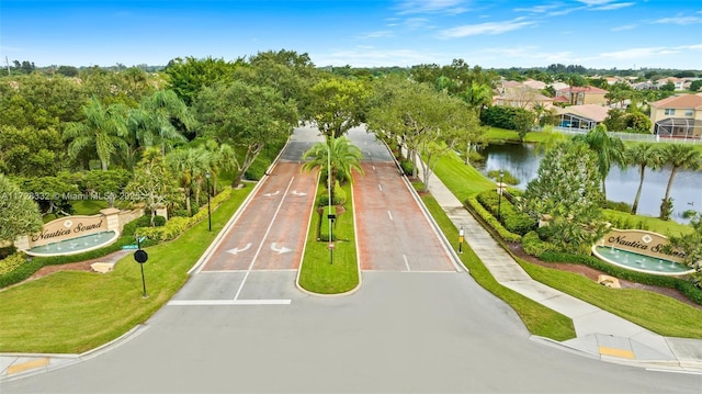 surrounding community featuring a water view and a yard