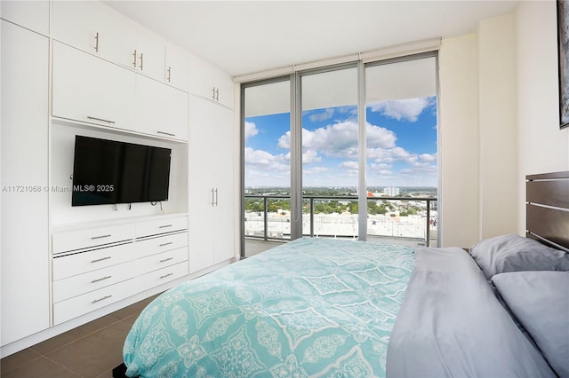 tiled bedroom featuring access to exterior and expansive windows