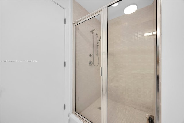 bathroom featuring a shower with door