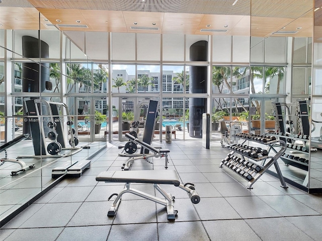 gym with a wall of windows and french doors