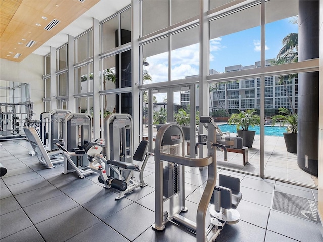 gym with expansive windows and a towering ceiling