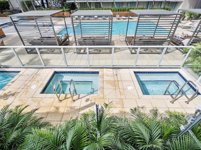 view of swimming pool featuring a community hot tub