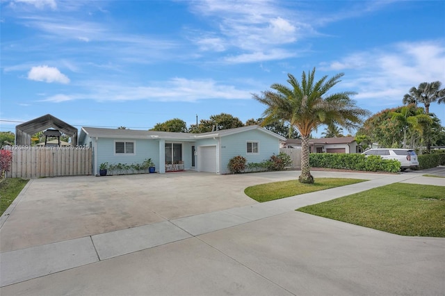 ranch-style home featuring a front lawn, a garage, and a carport