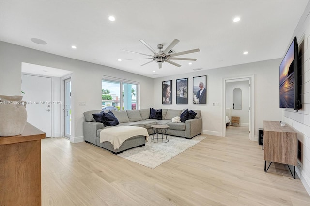 living room with ceiling fan and light hardwood / wood-style floors