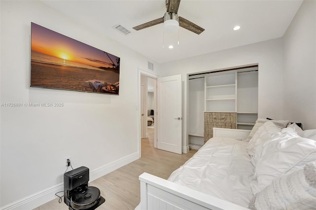 bedroom featuring light wood-type flooring, ceiling fan, and a closet