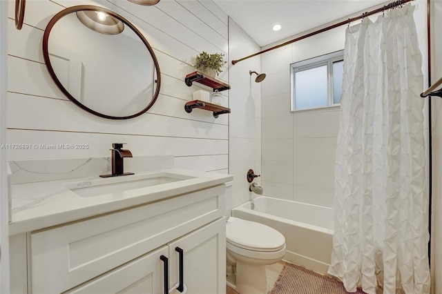 full bathroom featuring toilet, vanity, wooden walls, and shower / tub combo with curtain