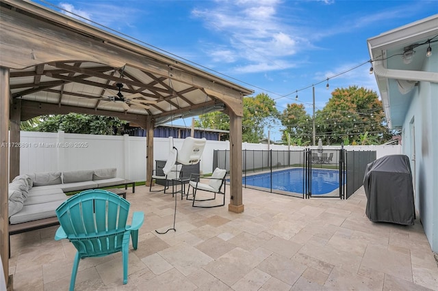 view of swimming pool with ceiling fan, a grill, an outdoor living space, and a patio