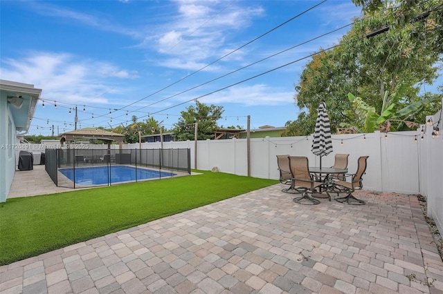 view of pool with a patio and a yard