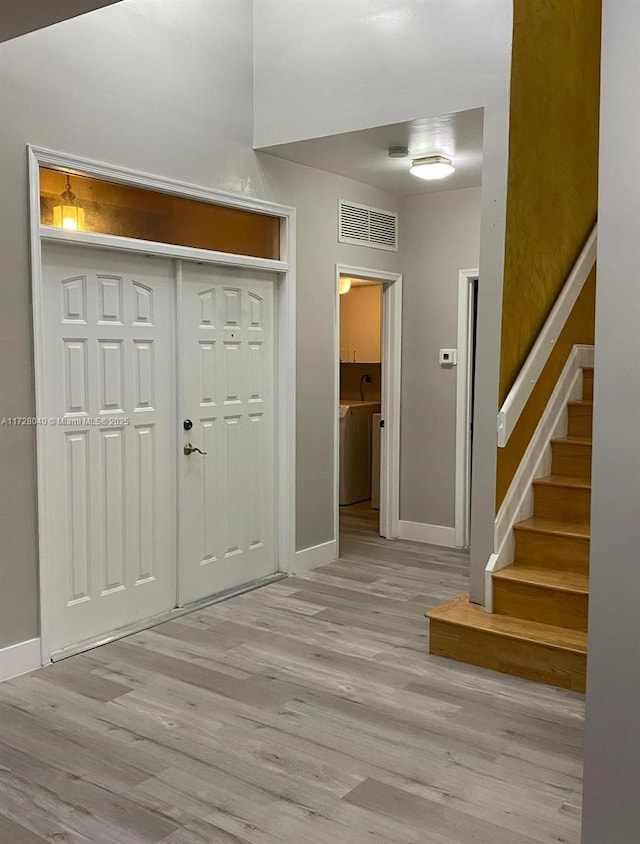 entrance foyer featuring light wood-type flooring