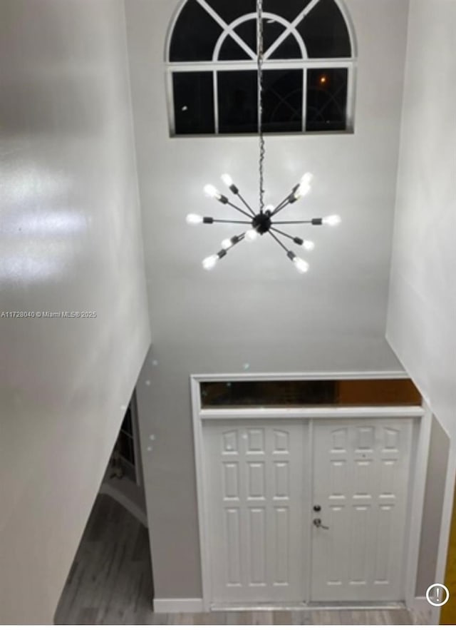 details featuring wood-type flooring and a notable chandelier