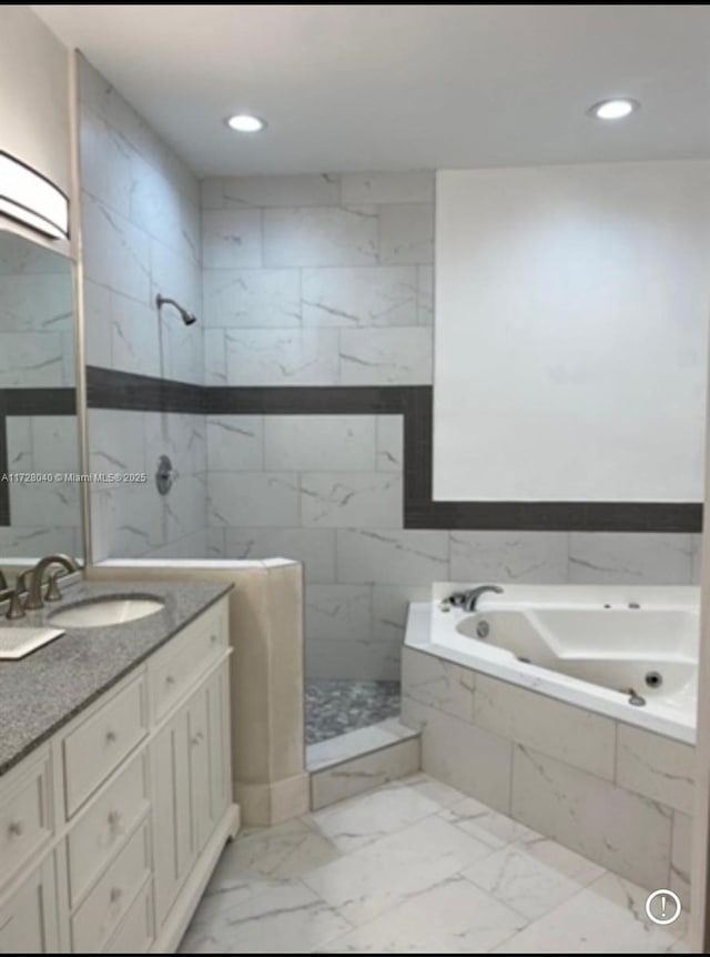 bathroom featuring vanity and separate shower and tub