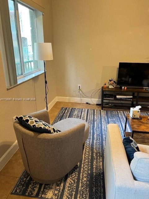 living room with tile patterned flooring