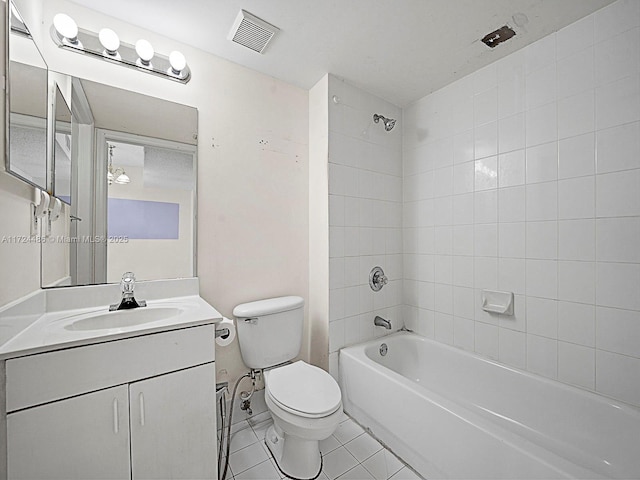 full bathroom featuring tile patterned floors, toilet, tiled shower / bath combo, and vanity