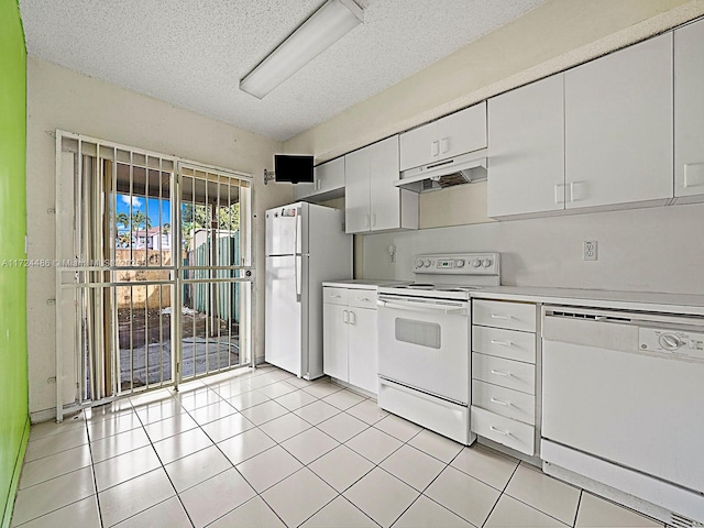 kitchen with light tile patterned floors, white appliances, white cabinetry, and a textured ceiling