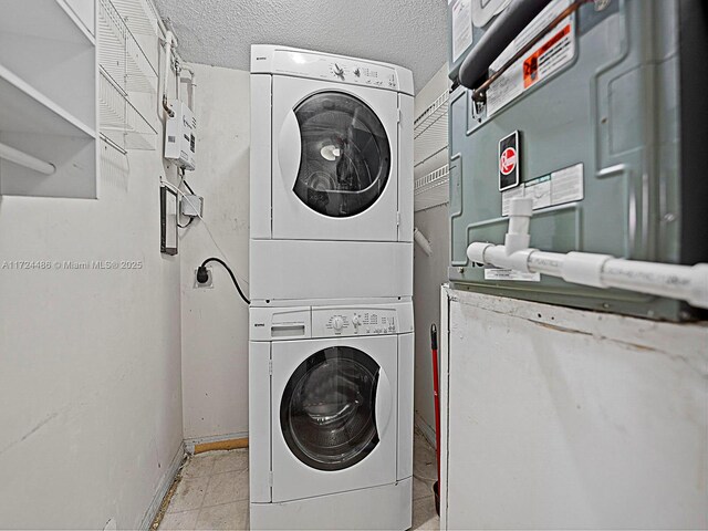 washroom featuring stacked washer / dryer and a textured ceiling