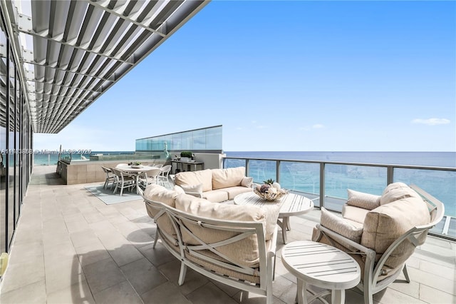 balcony with a water view and an outdoor living space