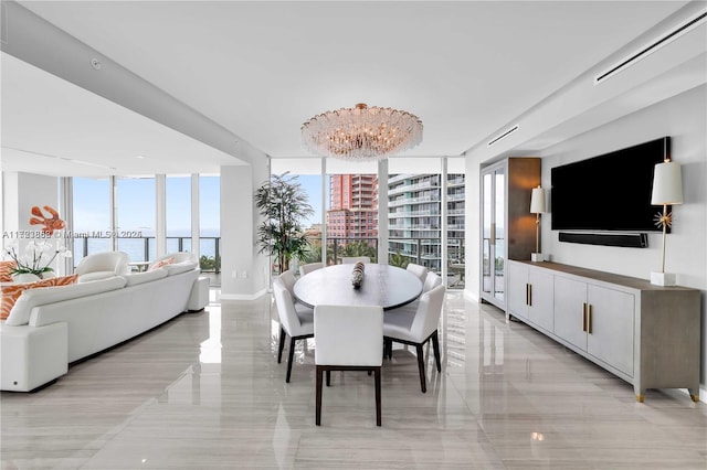 dining area with a water view, expansive windows, and a chandelier