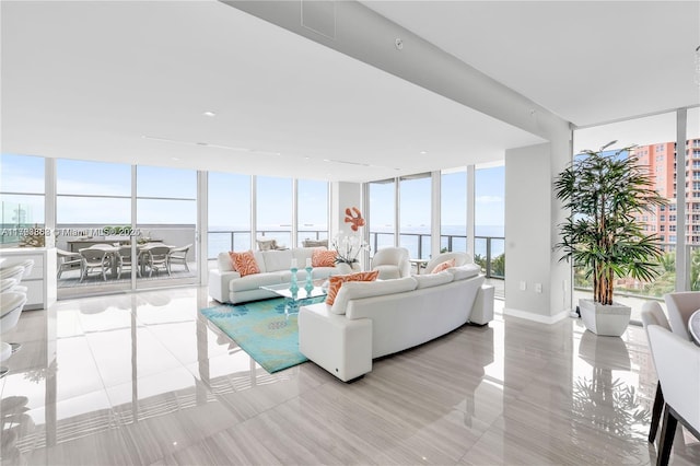 living room with floor to ceiling windows and a water view