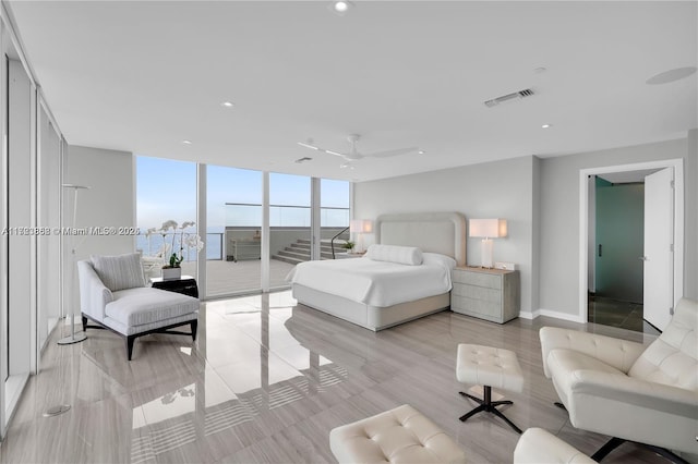 bedroom featuring expansive windows, access to exterior, and ceiling fan