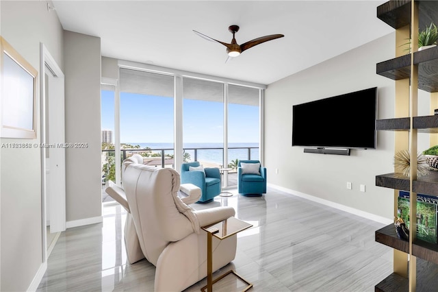 living room featuring a wall of windows and ceiling fan