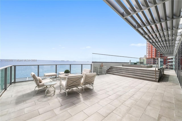 view of patio featuring a balcony and a water view