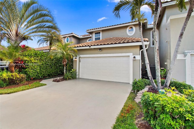 mediterranean / spanish-style house with a garage