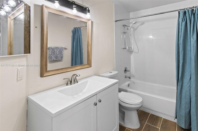 full bathroom featuring toilet, shower / bath combination with curtain, and vanity