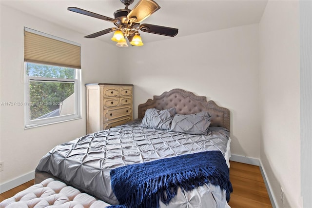 bedroom with ceiling fan and hardwood / wood-style flooring