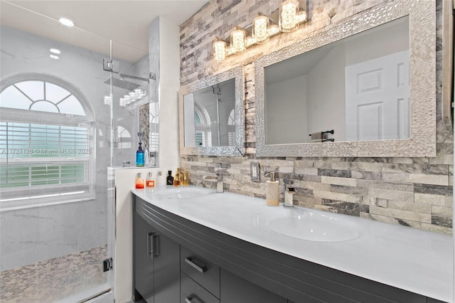 bathroom featuring a shower with shower door, backsplash, and vanity