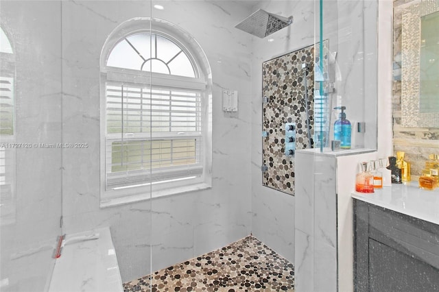 bathroom featuring vanity and a tile shower