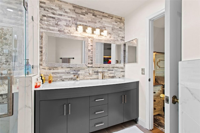 bathroom featuring a shower with shower door, decorative backsplash, and vanity