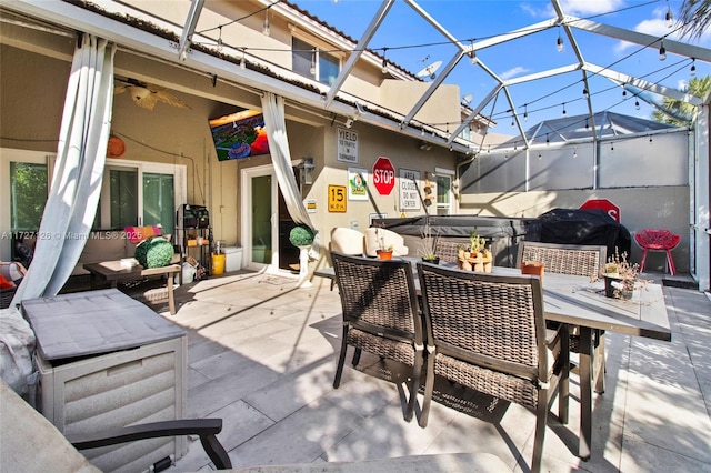 view of patio with glass enclosure, a hot tub, and a grill