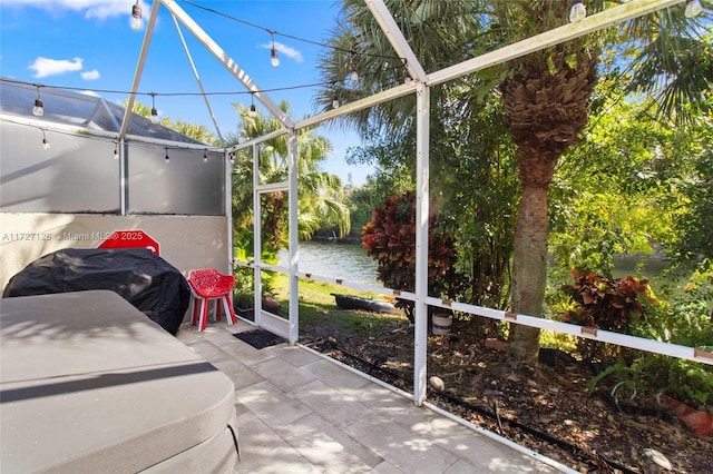 unfurnished sunroom featuring a water view