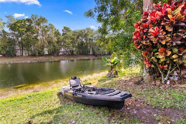 view of yard with a fire pit and a water view