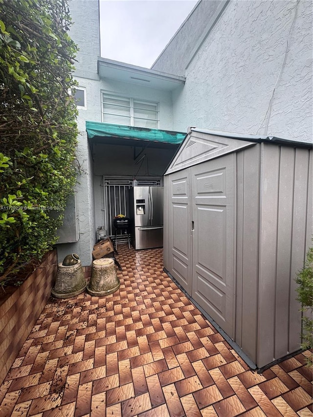 view of patio / terrace with a storage shed