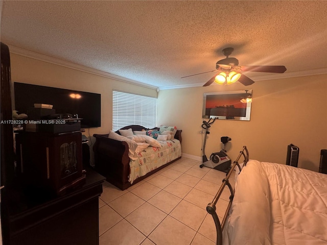 bedroom featuring ceiling fan, light tile patterned floors, ornamental molding, and a textured ceiling