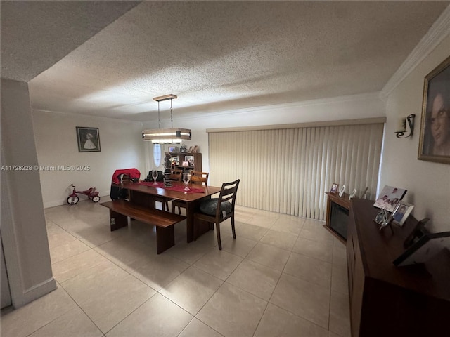 tiled dining room with a textured ceiling and crown molding