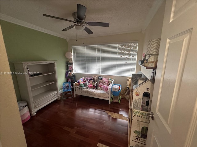 interior space featuring ceiling fan, dark hardwood / wood-style floors, crown molding, and a textured ceiling